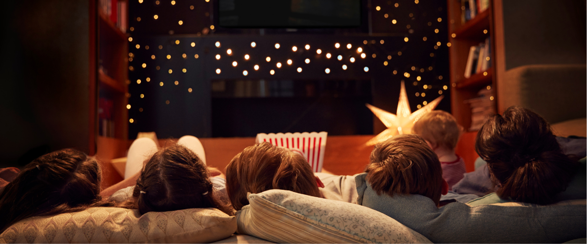 Image Of A Family Watching A Movie In Their Home