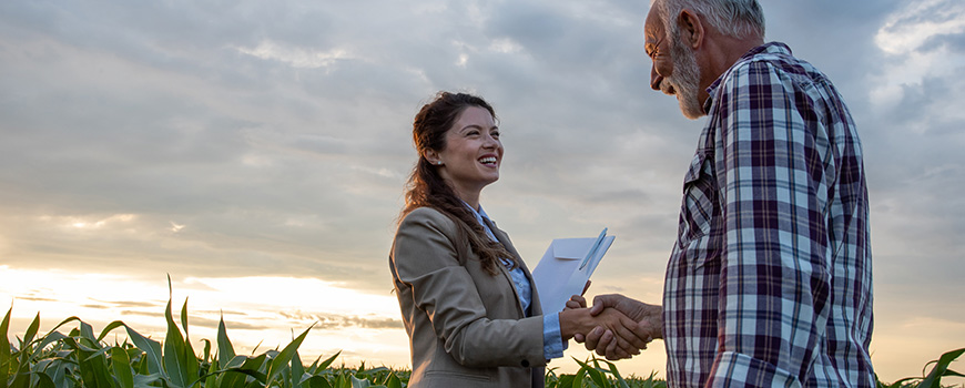 Farmer Talkin With Banker In Field Dealing With Financial Problems