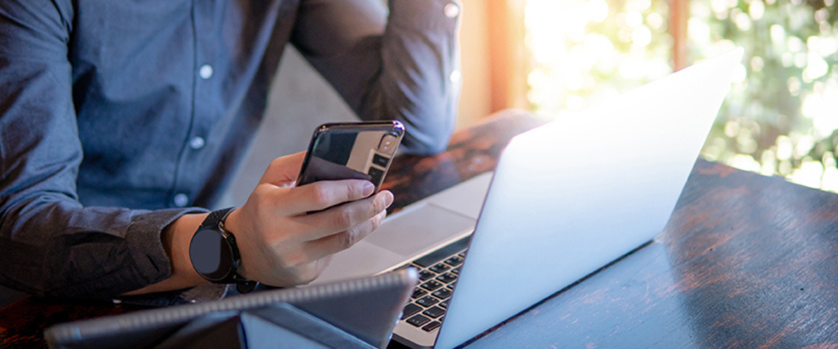 Image of Man on Phone and Computer