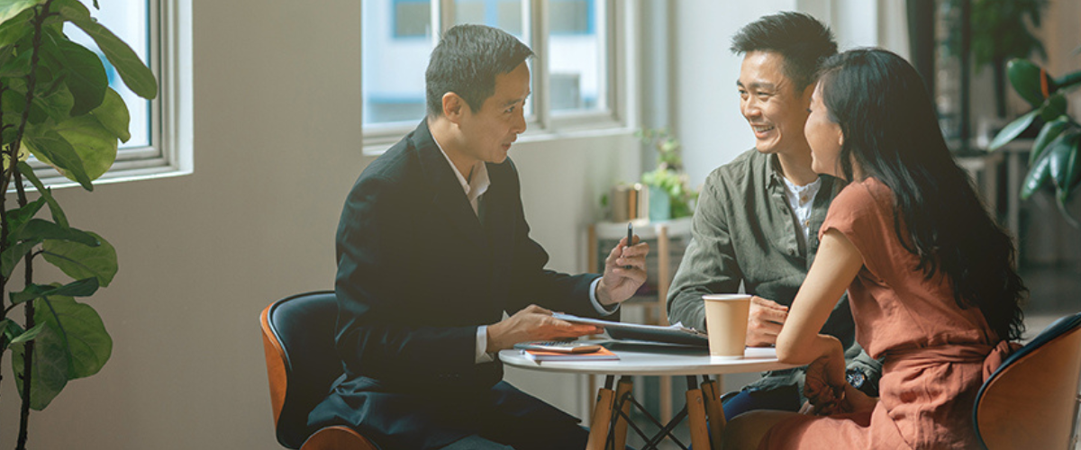 Picture of Couple Talking with Advisor at Table