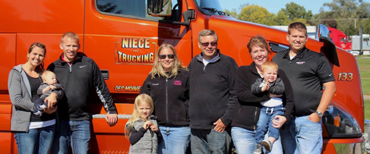 Image of Niece Trucking Family in Front of Truck.