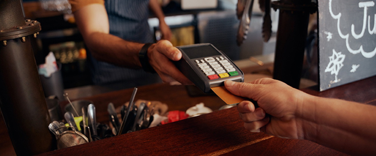 image of Someone Using a Card Scanner at Checkout