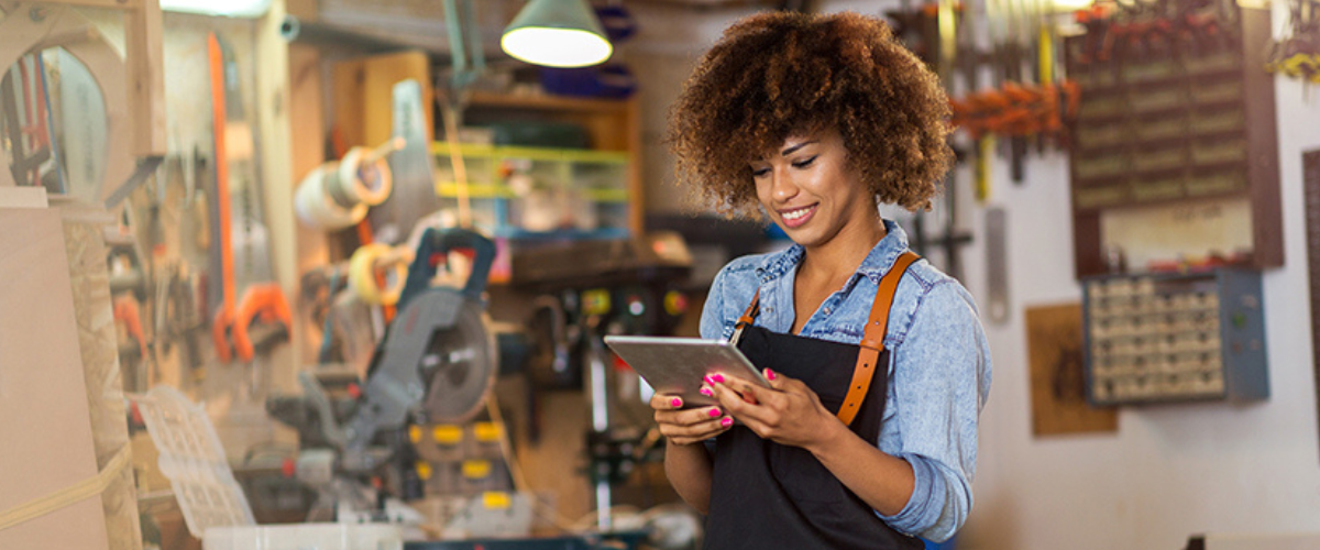 Woman on Tablet Searching How to Get a Small Business Loan,