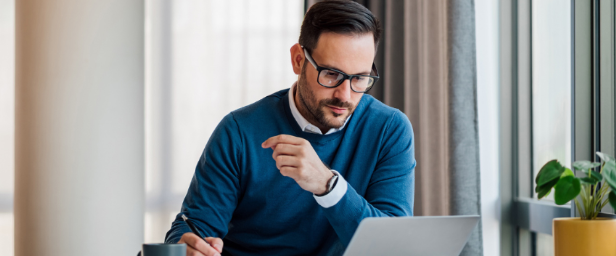 Image of a Small Business Owner Sitting Down Writing a Business Plan