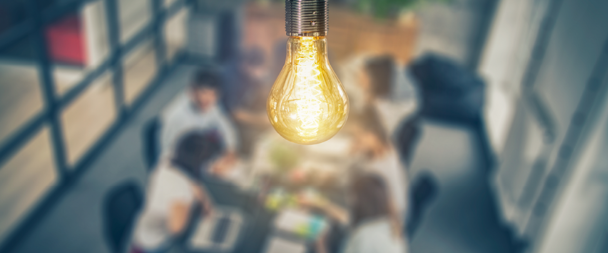 Image of Business People with a Light Bulb Symbolizing an Idea.