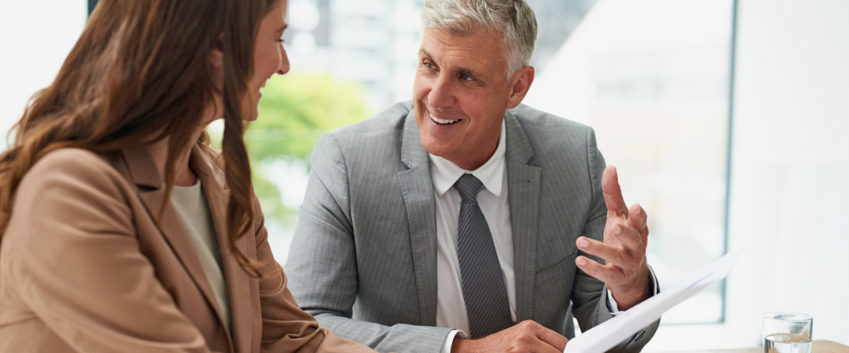 A Female Small Business Owner Meeting With A Community Banker To Sign A Small Business Loan