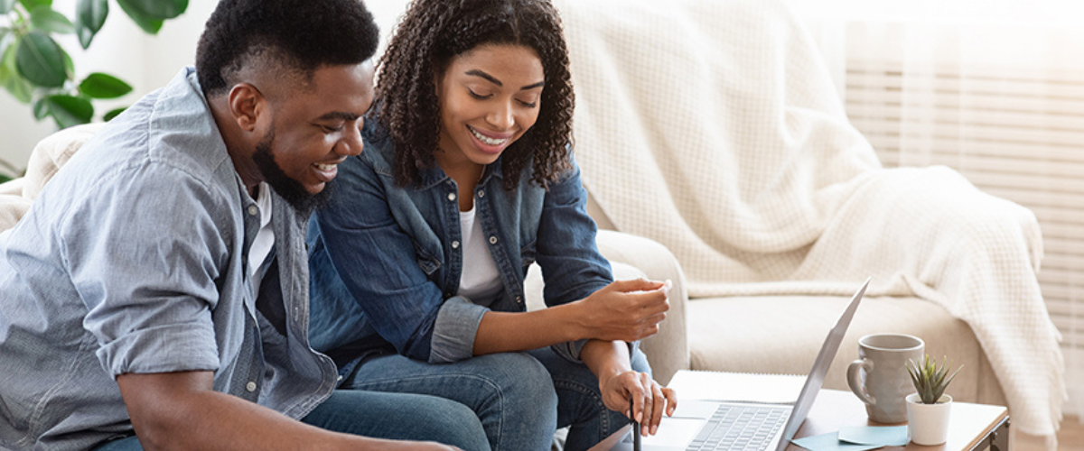 Image of Couple Looking at Computer and Paper