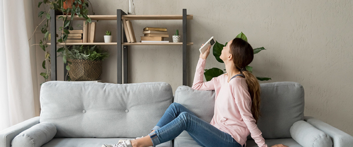 Image of Woman Using AC in Home