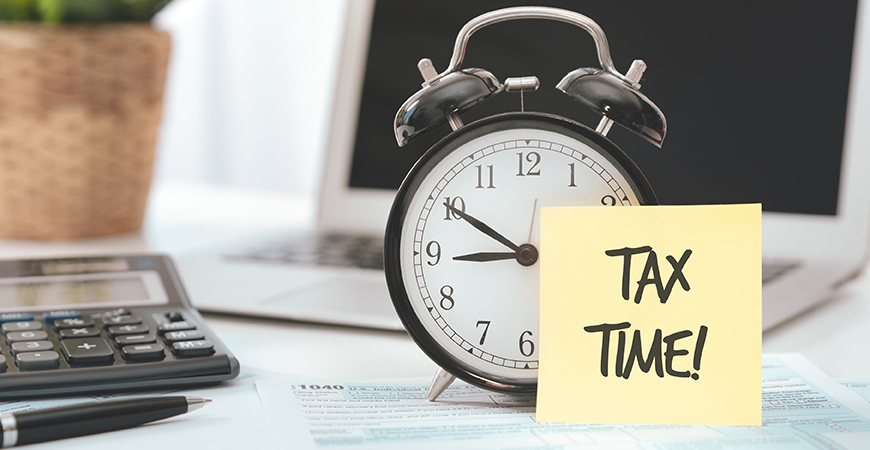 Tax Time Image of Clock and Sticky Note