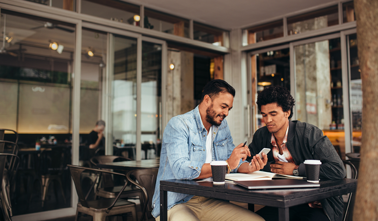 Image Of Two Men Looking At Their Finances