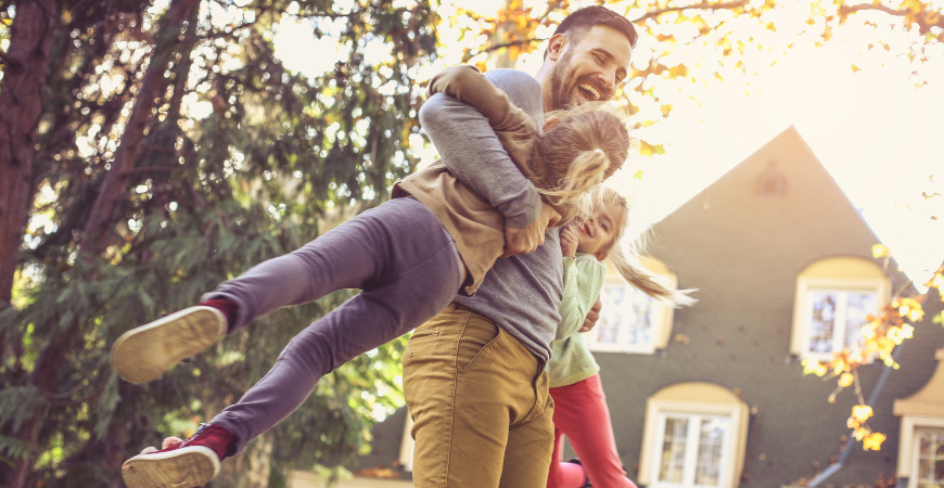 Family Playing Outside In Their yard