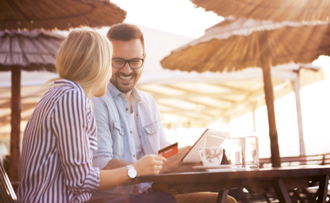 Couple Using Their Prepaid Card While On Vacation