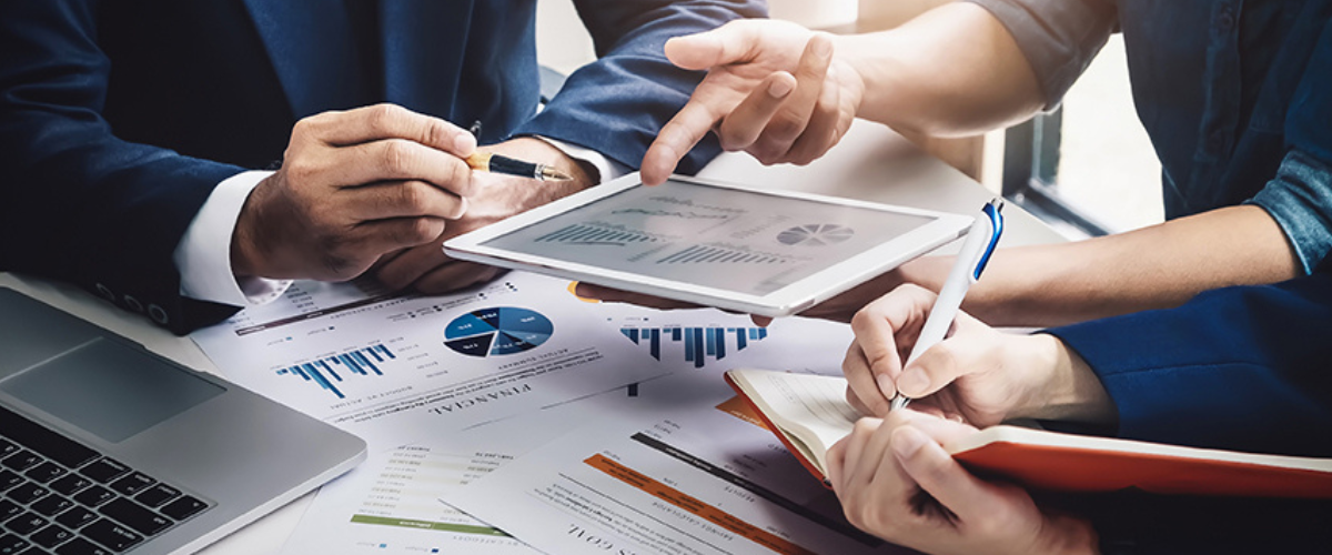 Image of Group of People Looking at Charts and Documents